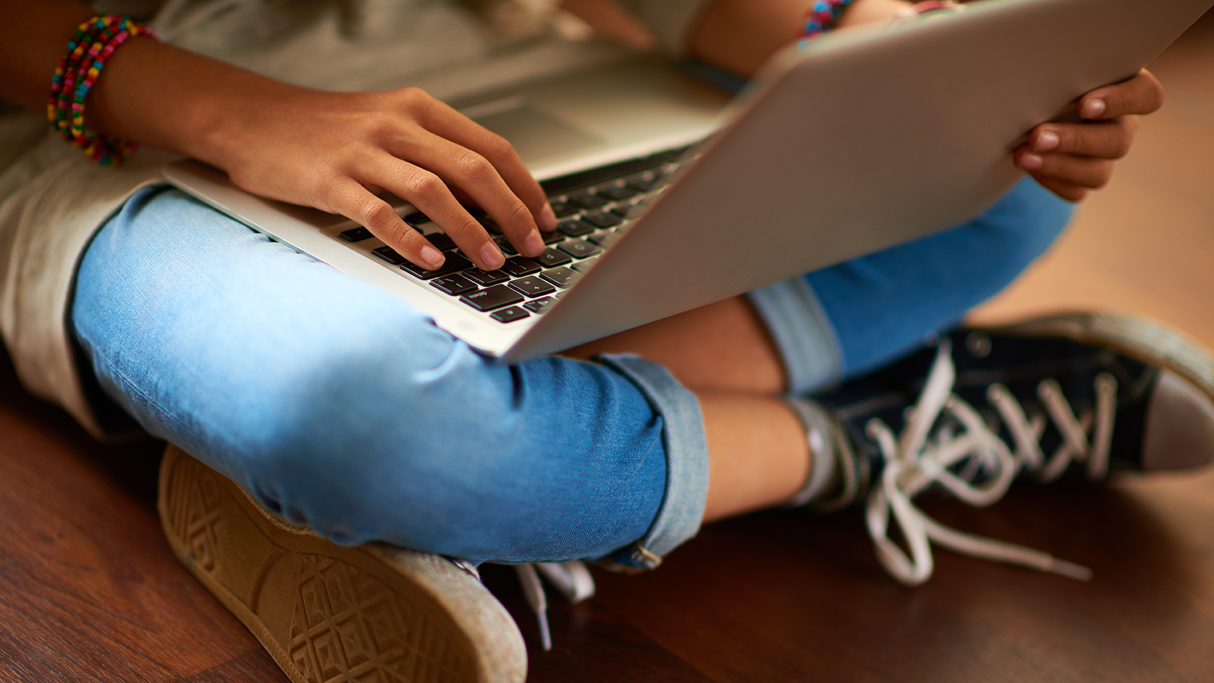 closeup of girl typing on a laptop